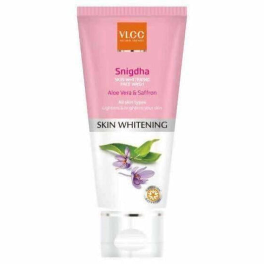 A plastic tube of VLCC Snigdha Skin Whitening Face Wash with a pump dispenser, featuring pink and yellow branding and an image of Aloe Vera and Saffron, indicating the product's skin whitening benefits.