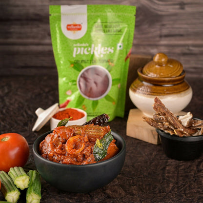 Bowl of food with a green packet labeled 'pichli' in the background on a wooden surface.