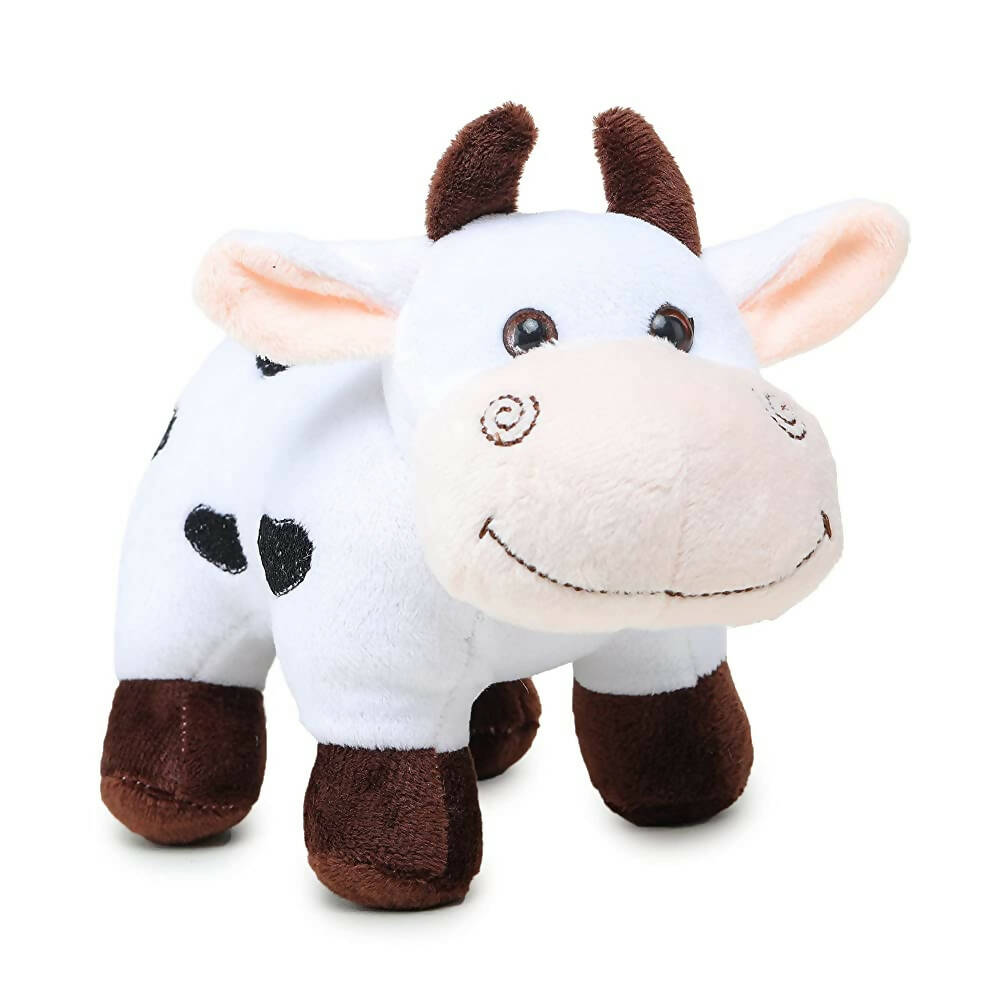 Plush cow toy on a white background