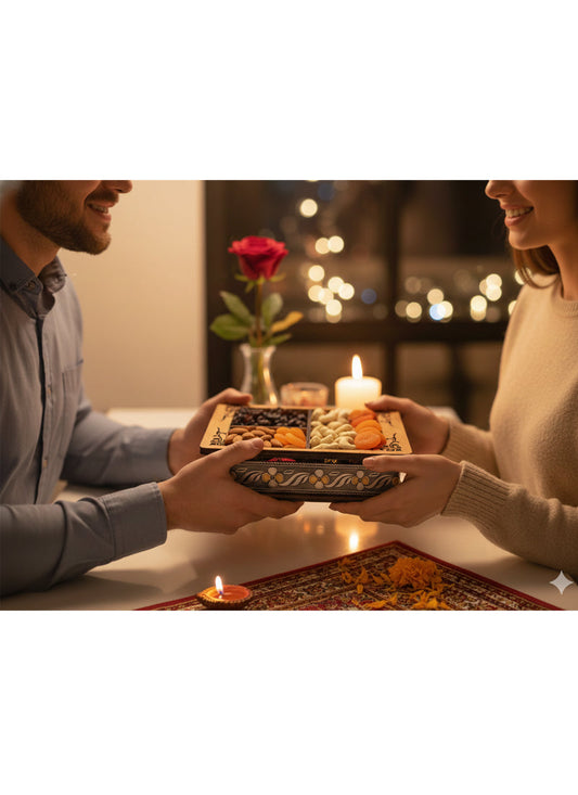 Man and woman exchanging a platter of food in a romantic setting with candles and a rose.