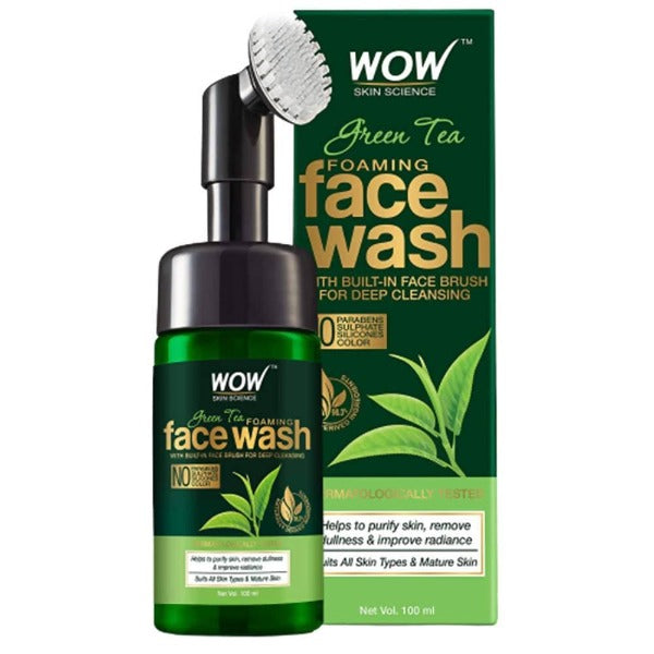 Green tea foaming face wash with built-in face brush and packaging on a white background