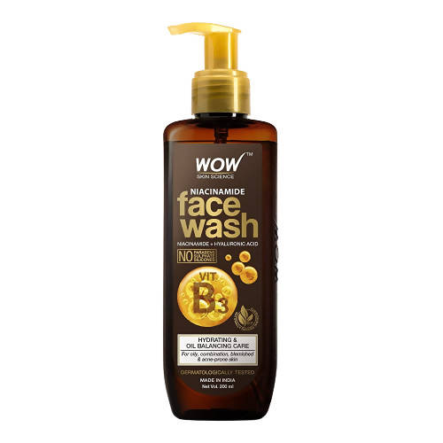Brown bottle of WOW Niacinamide face wash with gold pump on a white background