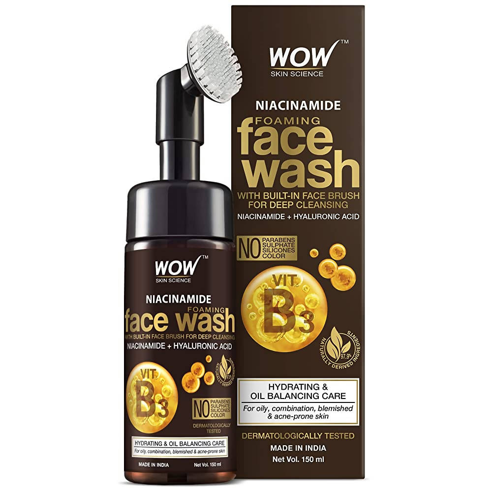 Wow Skin Science Niacinamide Foaming Face Wash with face brush and packaging on a white background
