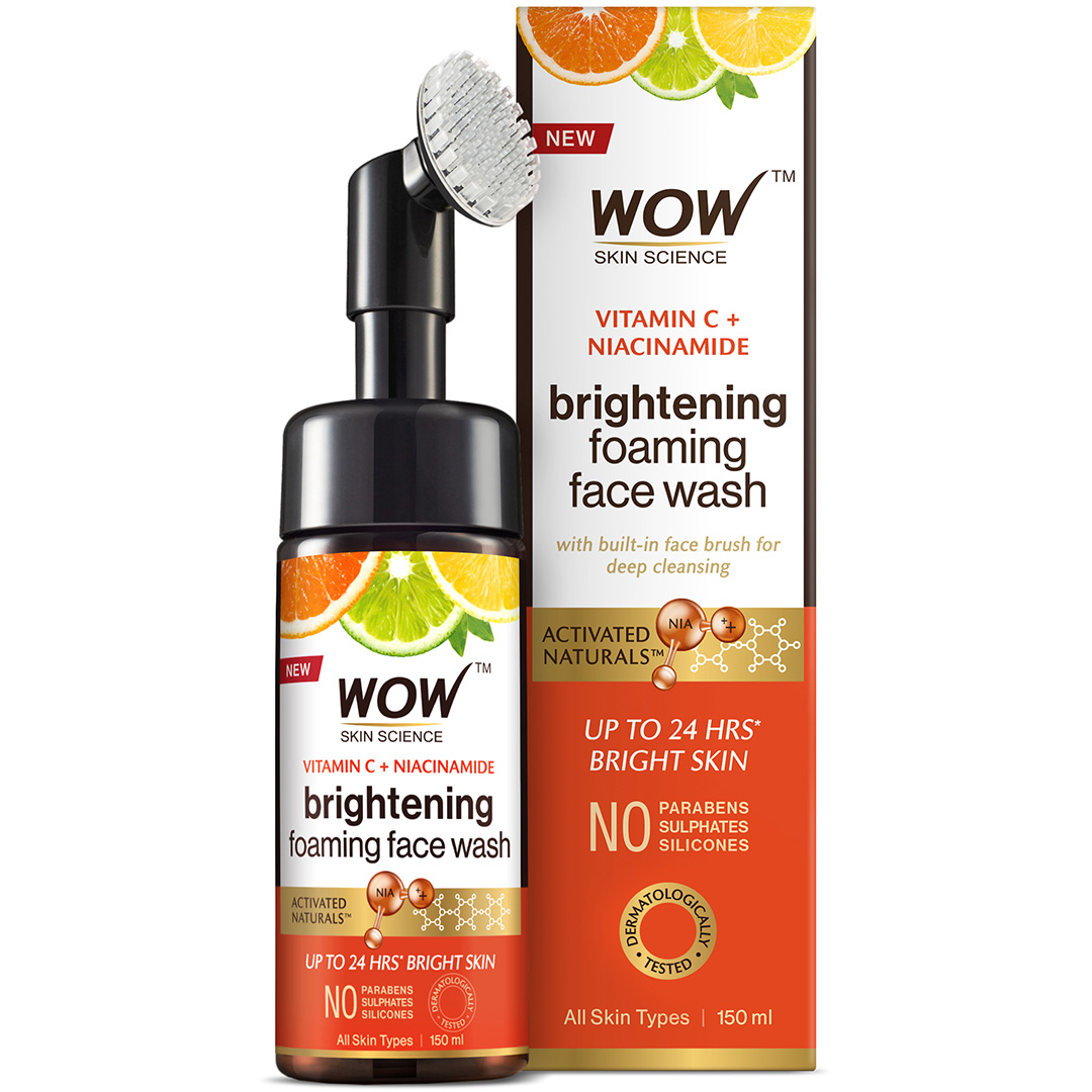 Packaging of Wow Skin Science Vitamin C & Niacinamide Brightening Foaming Face Wash with built-in face brush. The bottle is white with orange and black accents, and the box has the same color scheme with additional product information.